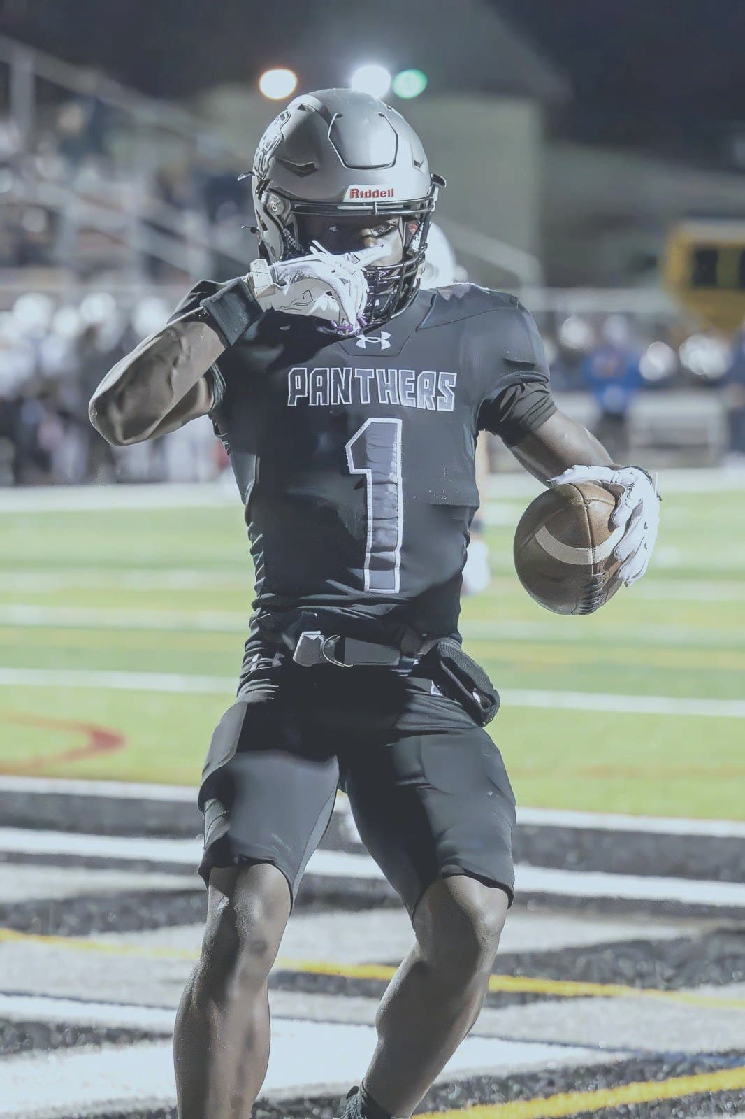 Panthers #1 celebrates a touchdown under the lights