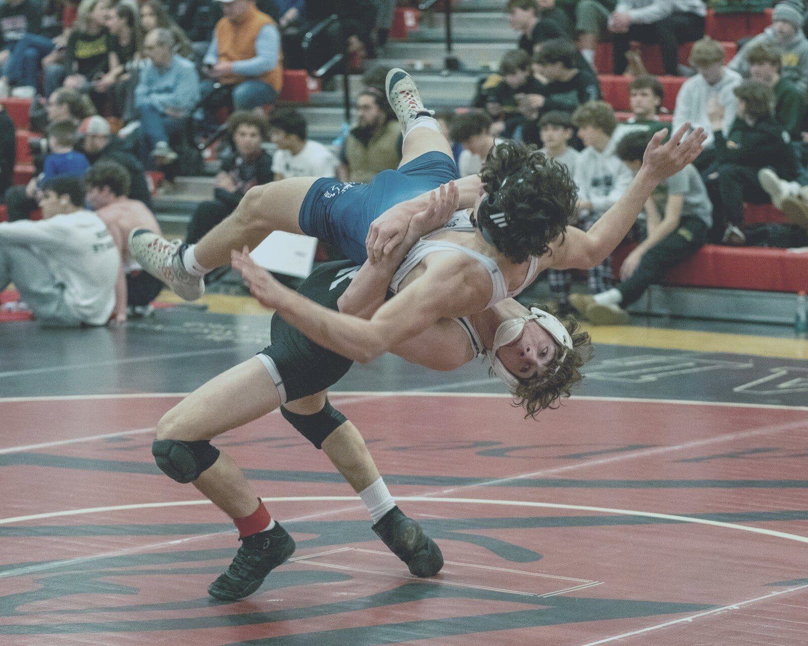 Wrestler executes suplex at packed tournament