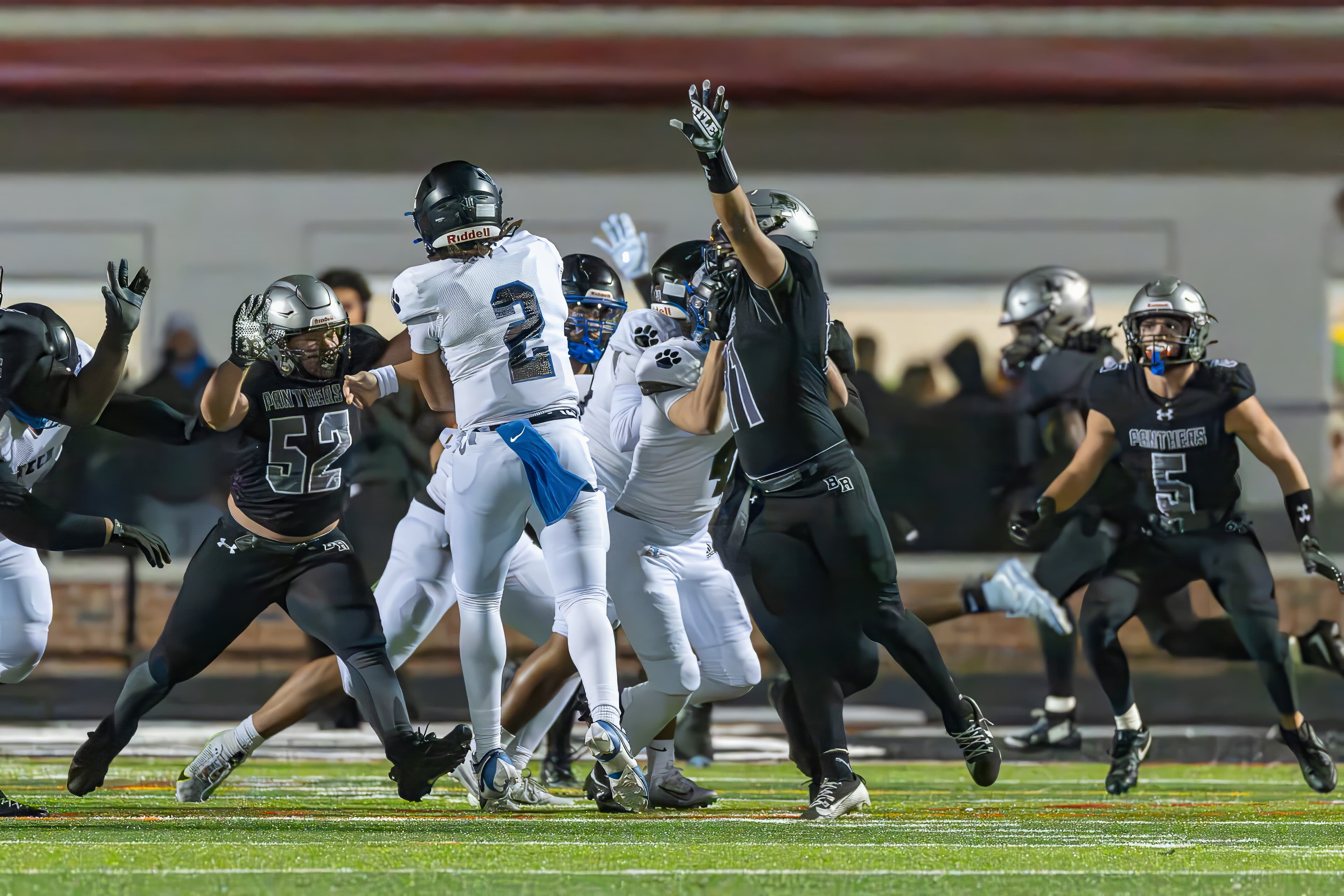 Quarterback scrambles under pressure in the pocket