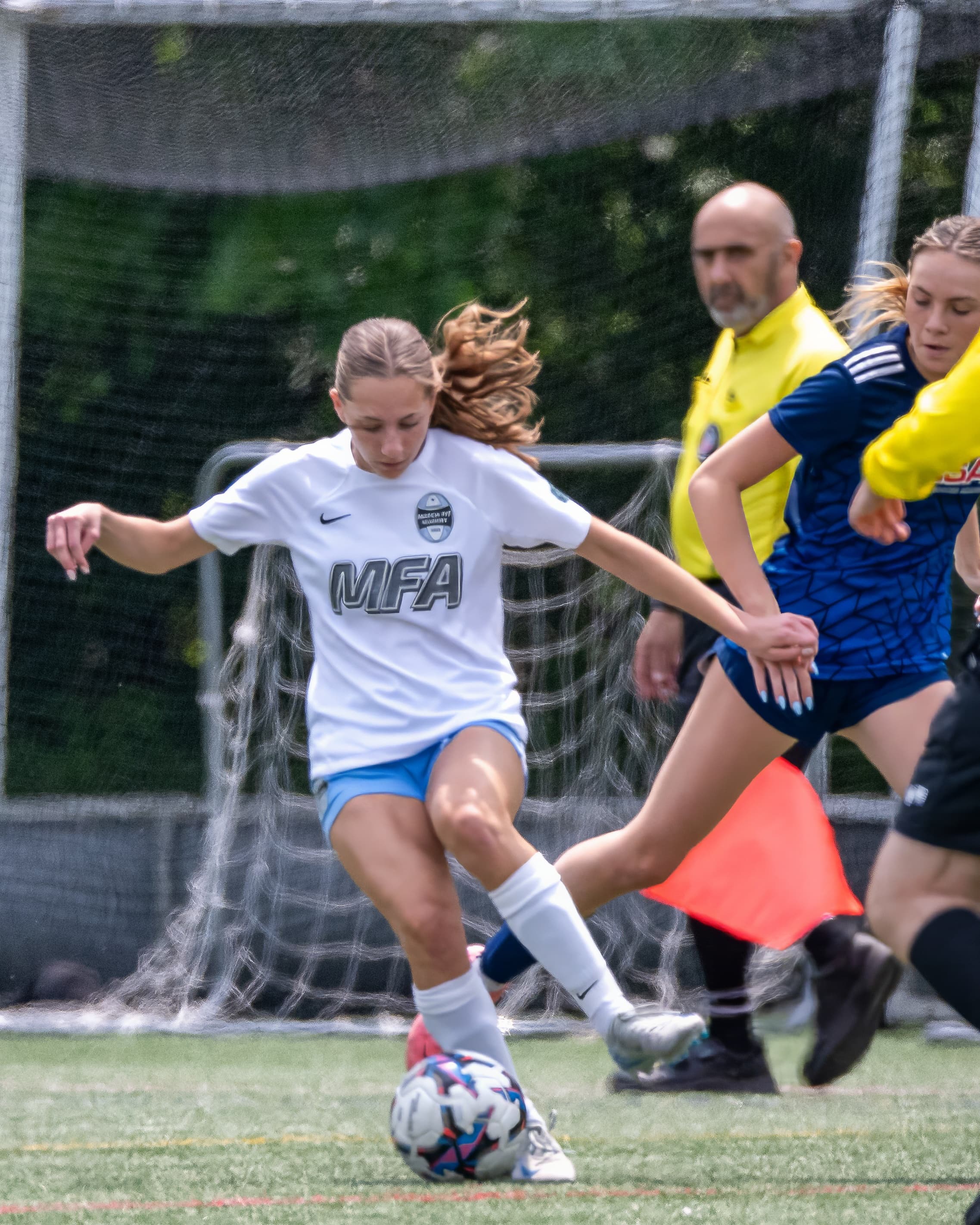 Midfielder controls the ball under pressure